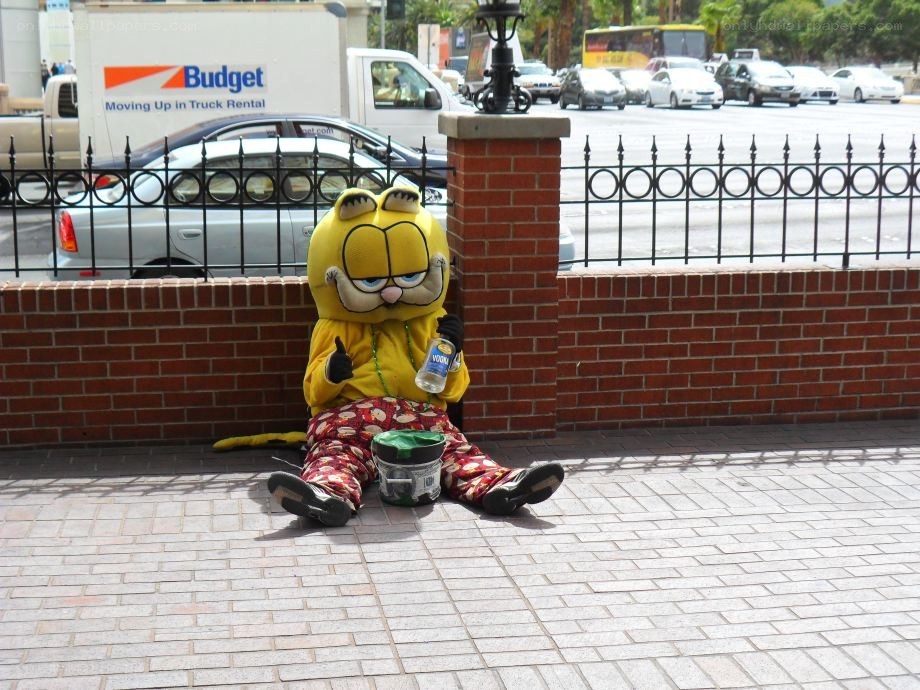 Garfield mascot sitting on sidewalk