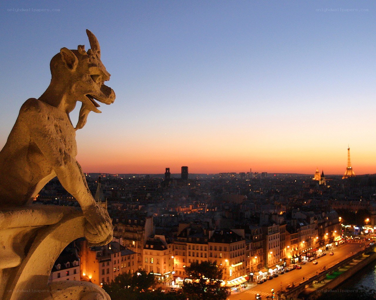 Gargoyle overlooking Paris at dusk