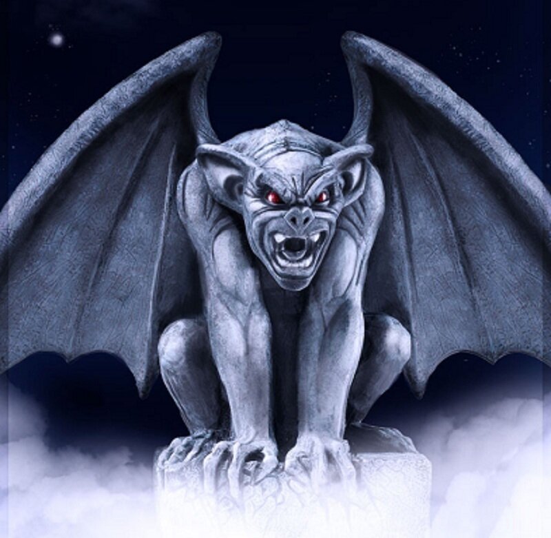 Gargoyle statue at night