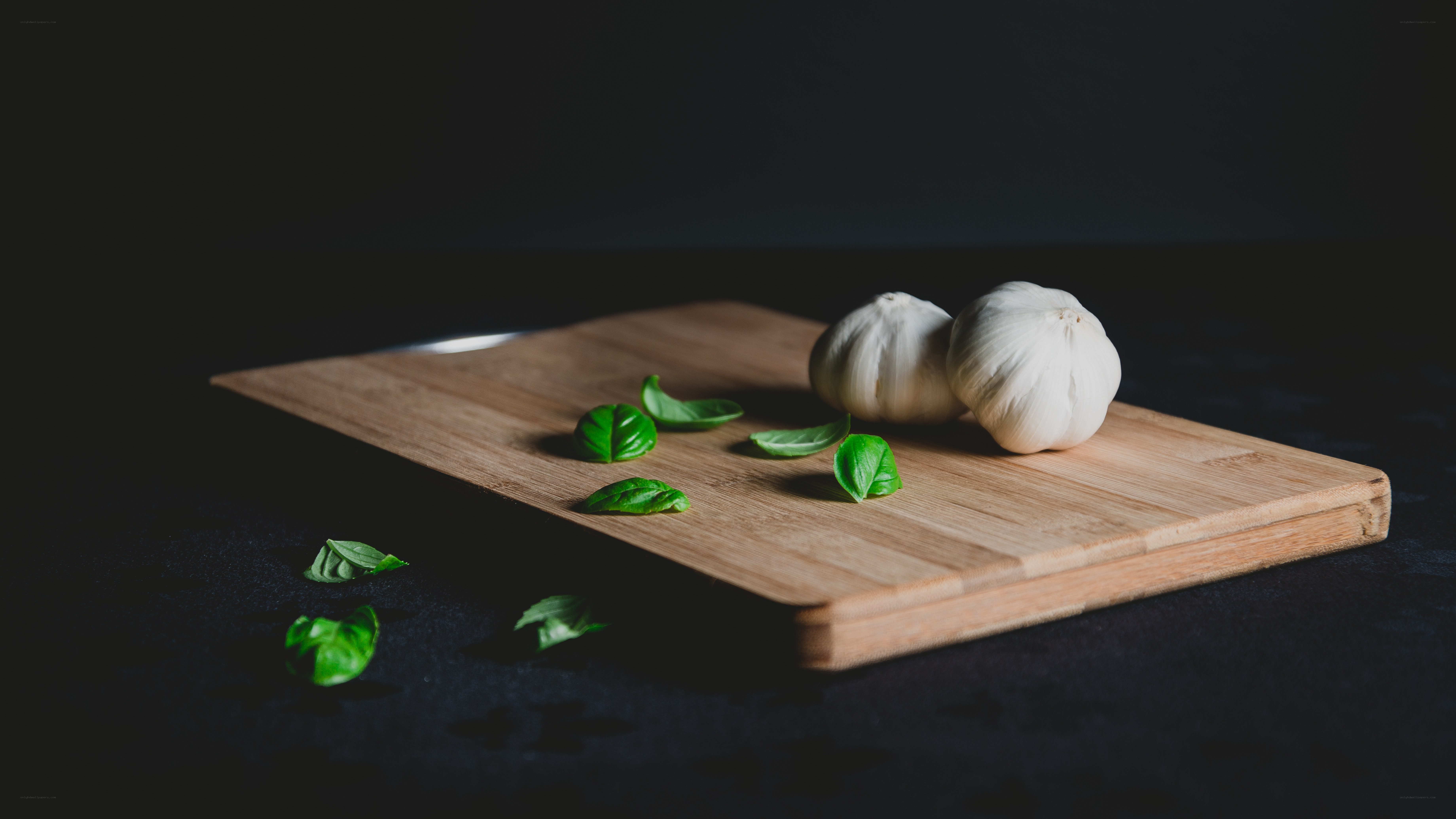 garlic and basil on cutting board