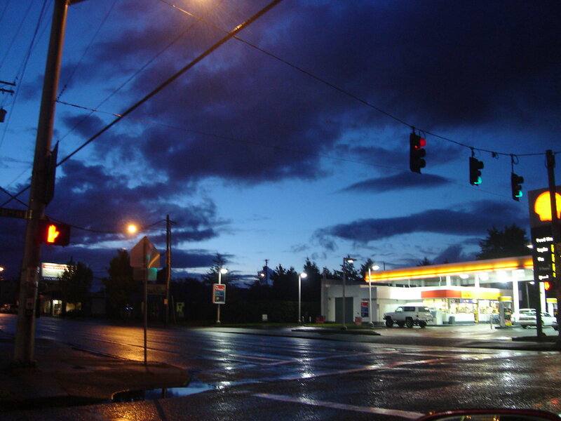 Gas station at dusk on wet street