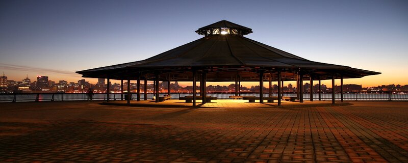 Gazebo at dusk with city skyline