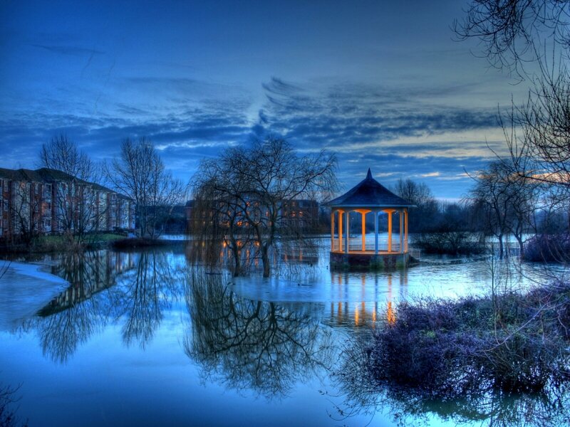 Gazebo in flooded park at dusk