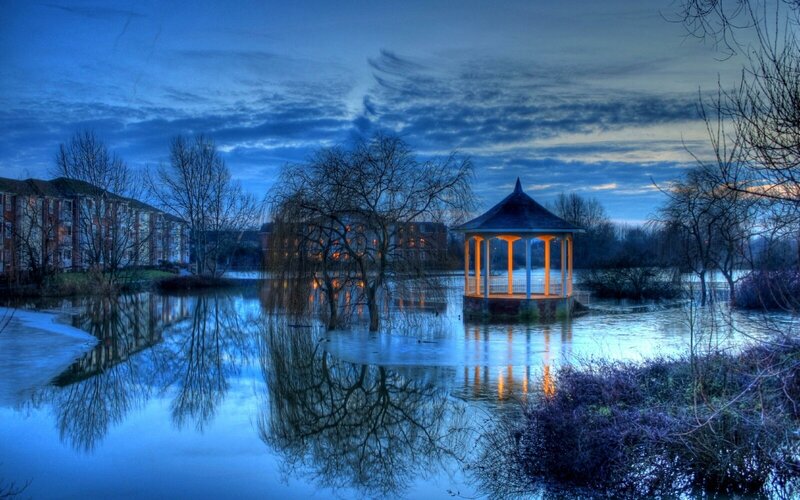 Gazebo on a flooded lake at dusk