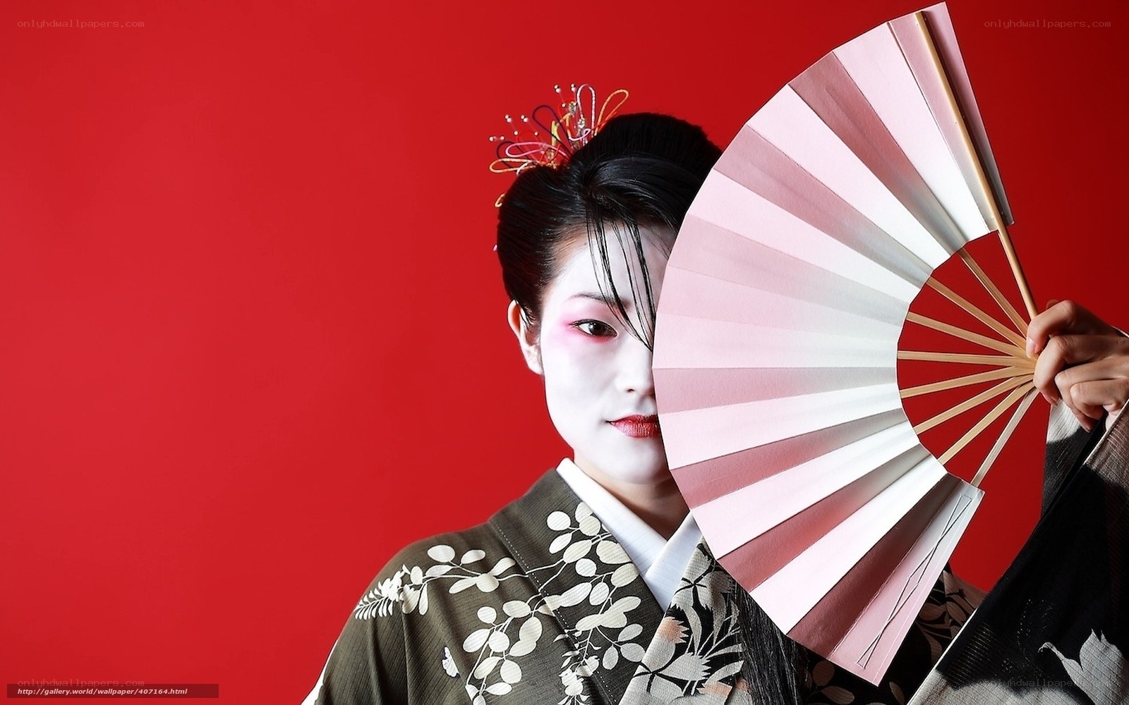 Geisha with fan against red