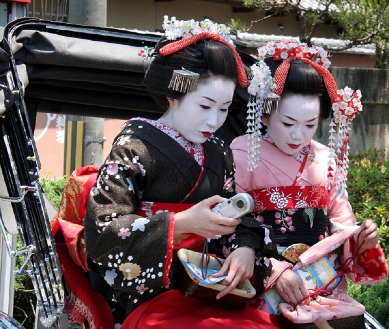 Geishas in a rickshaw