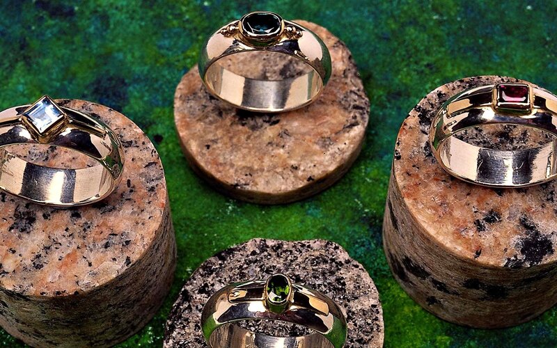 Gemstone rings on stone stands