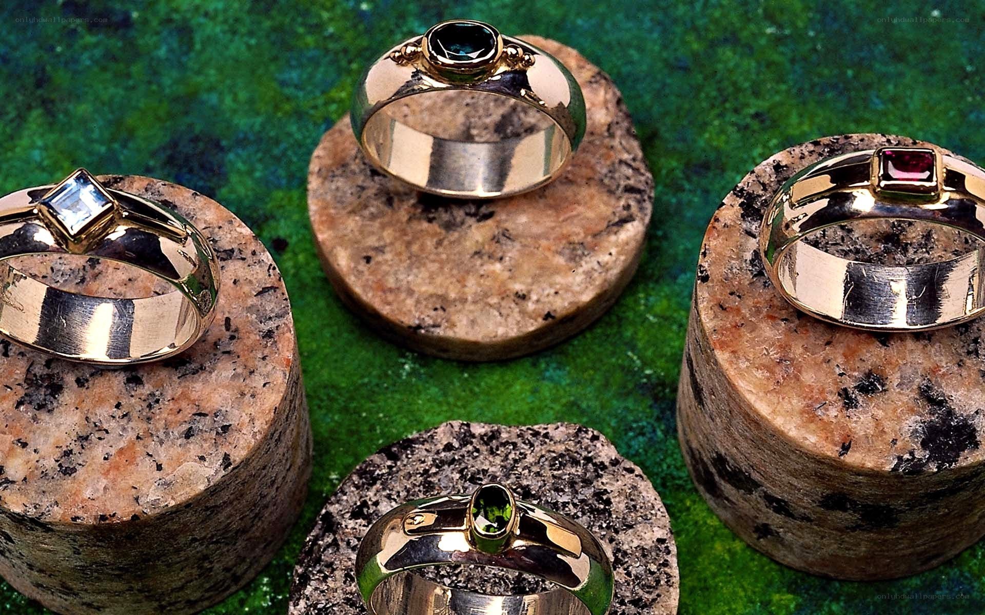 Gemstone rings on stone stands