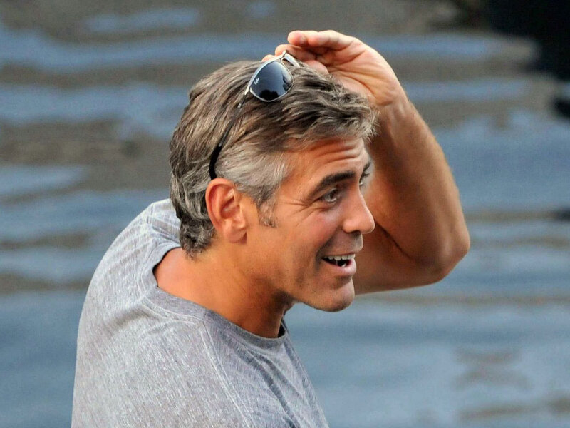 George Clooney smiling by water