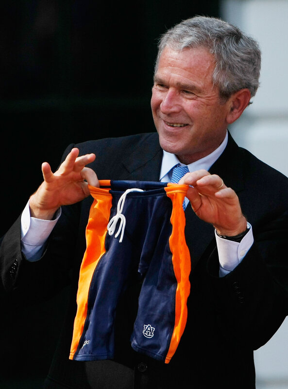 George W. Bush holding swim trunks