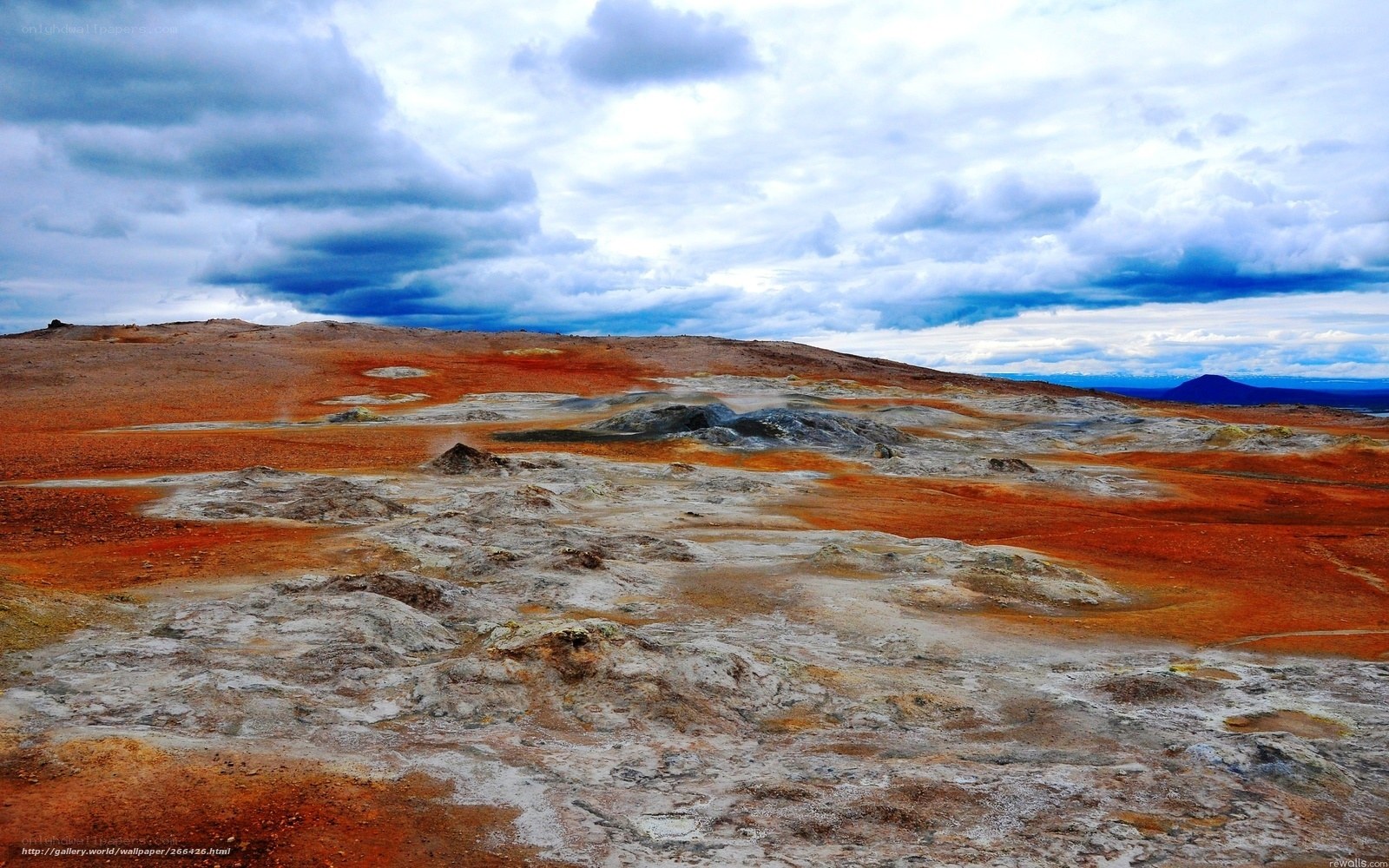 Geothermal landscape under cloudy sky