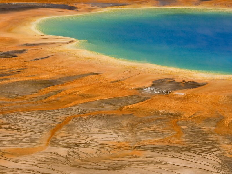 Geothermal pool with colorful mineral deposits