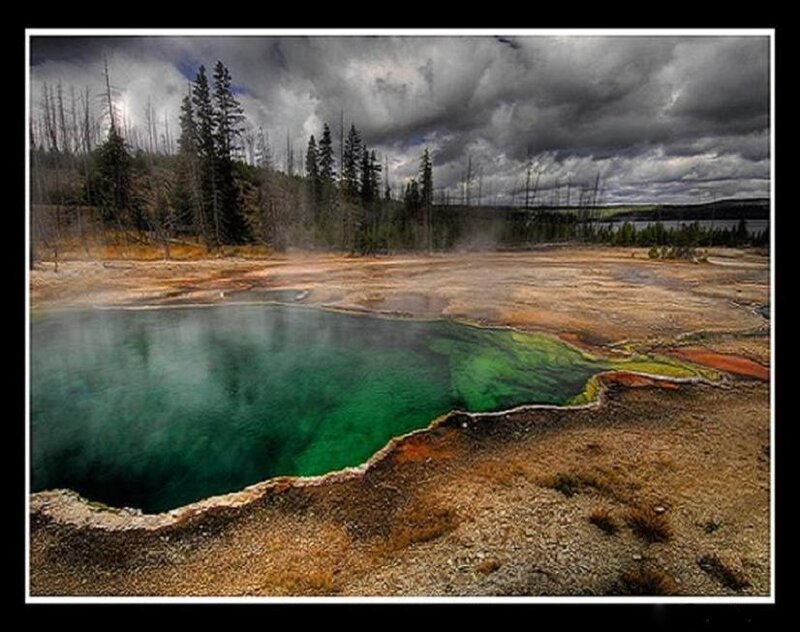geothermal spring under stormy sky