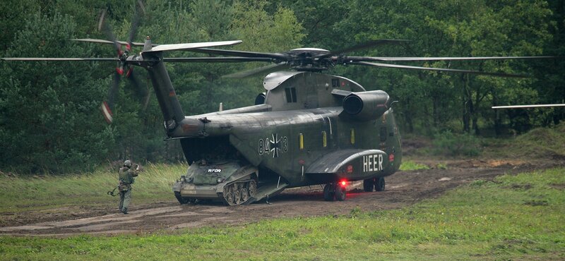 German military helicopter with tank
