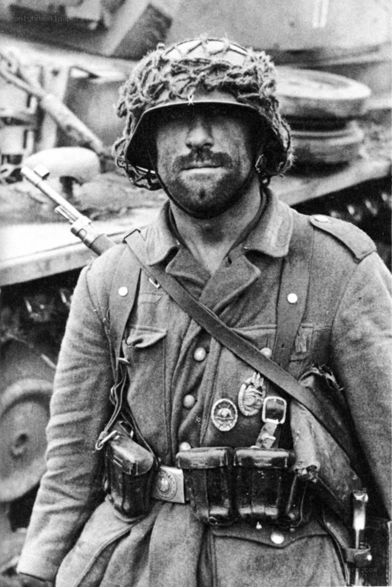 German soldier with tank in background