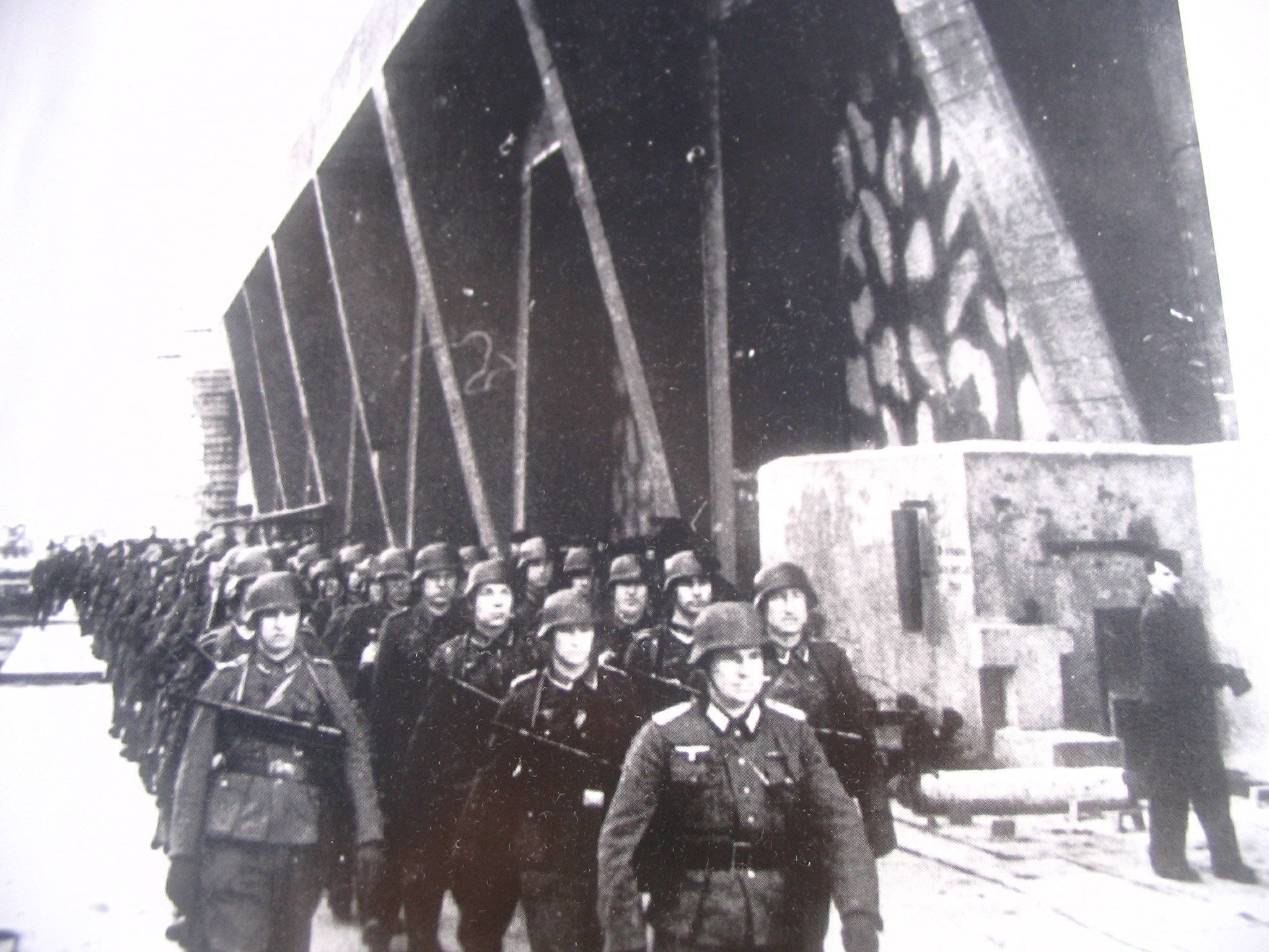 German soldiers marching under a bridge