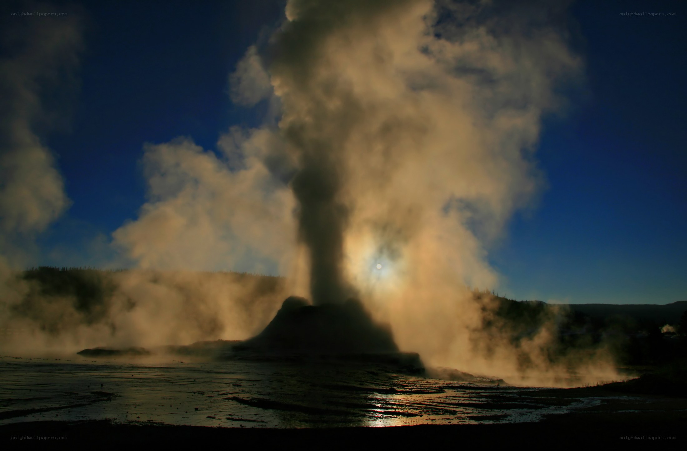 Geyser erupting at sunset