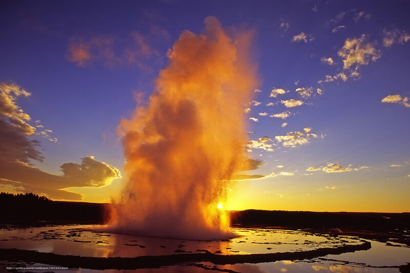 Geyser erupting at sunset