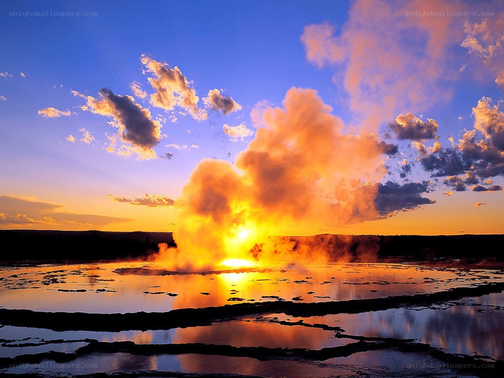Geyser erupting at sunset
