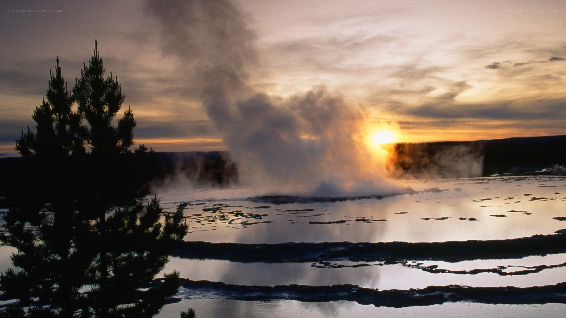geyser erupting at sunset