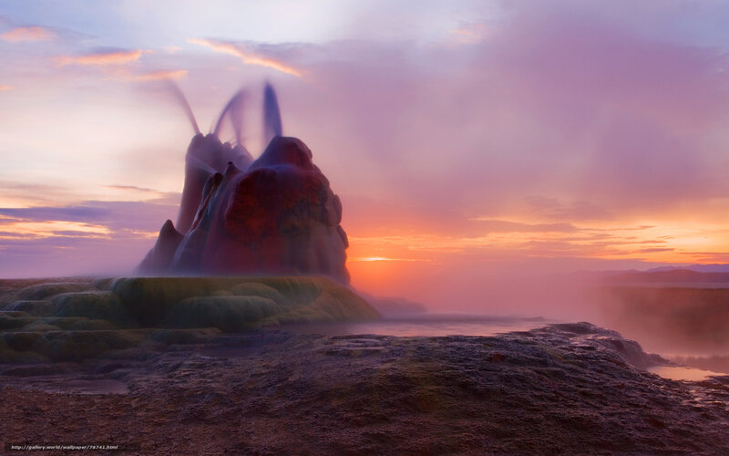 Geyser erupting at sunset