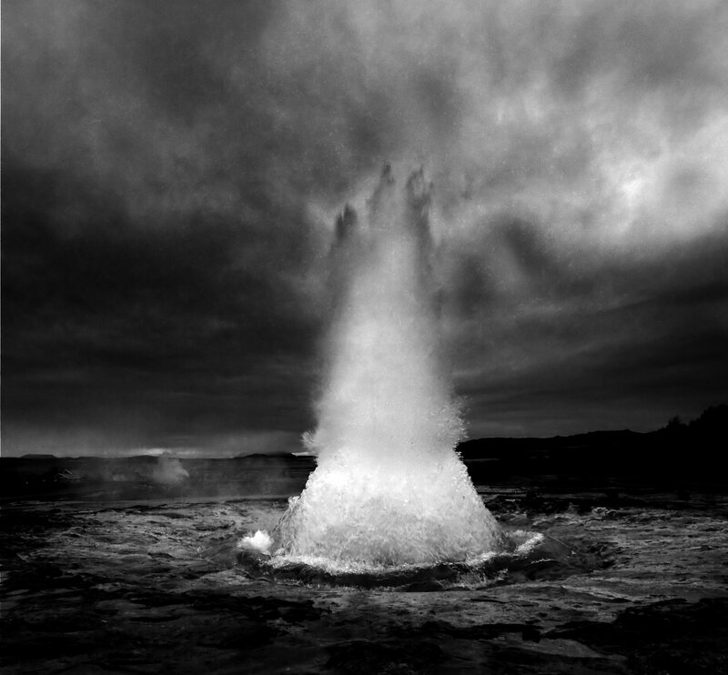 Geyser erupting in black and white