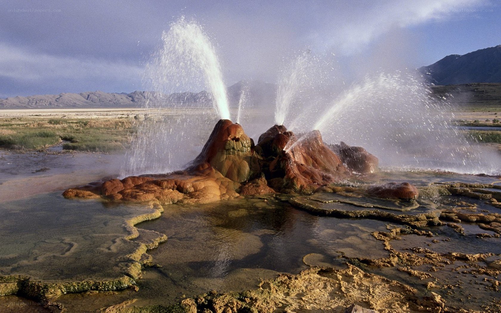 geyser erupting in desert