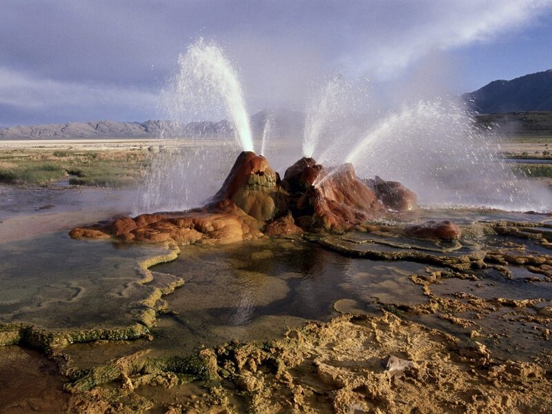 geyser erupting in desert