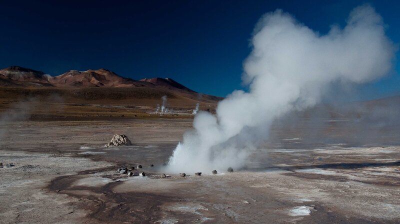 Geyser Erupting in Desert — Blue