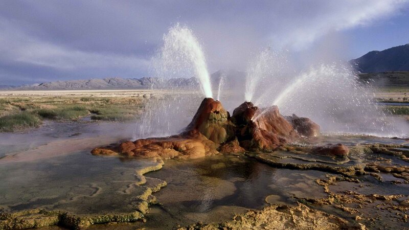 geyser erupting in desert