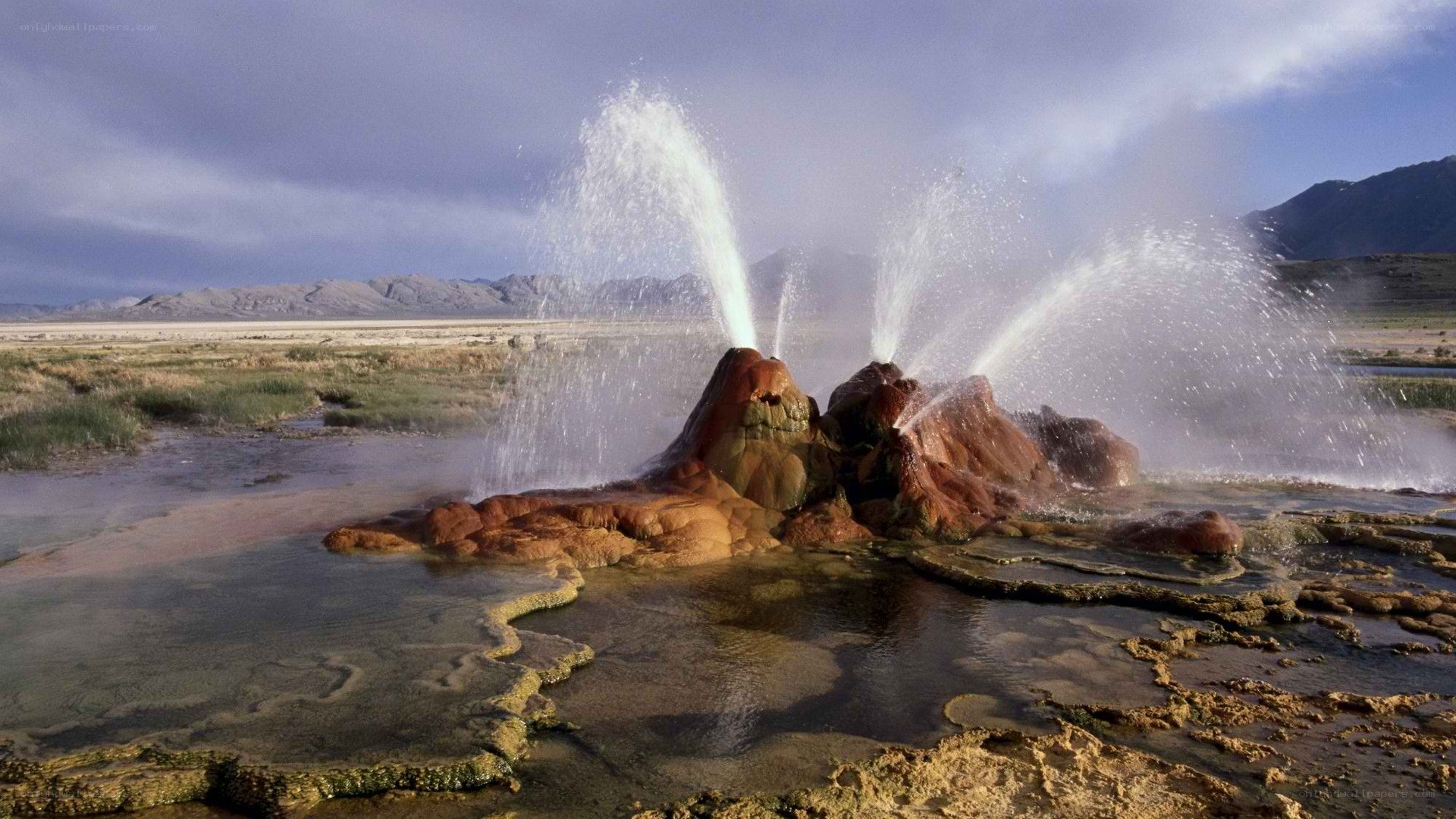 geyser erupting in desert