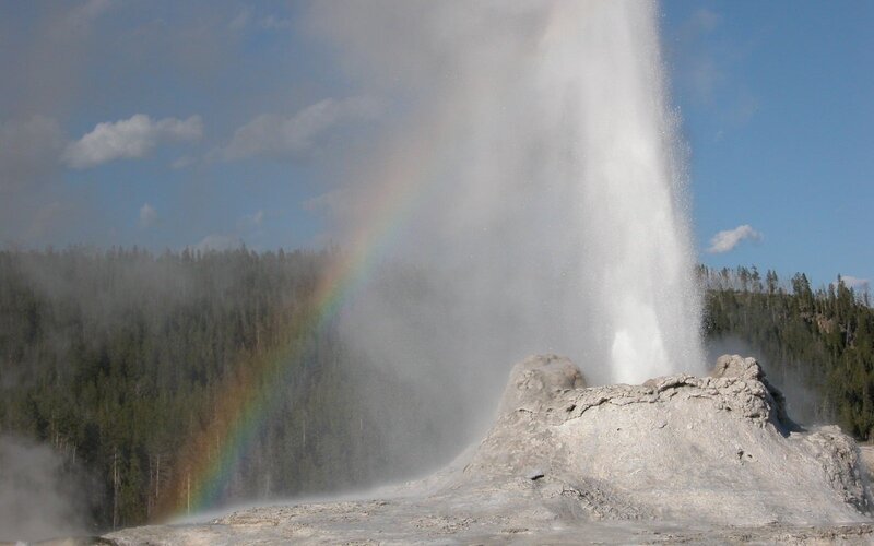 Geyser erupting with rainbow