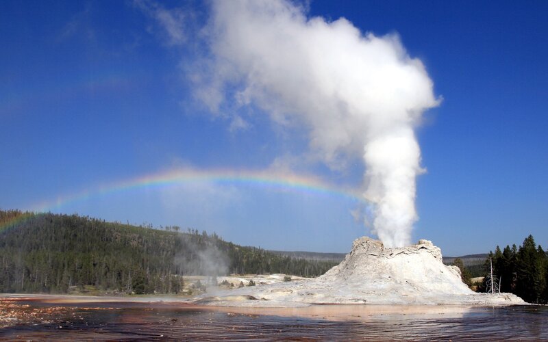 Geyser erupting with rainbow