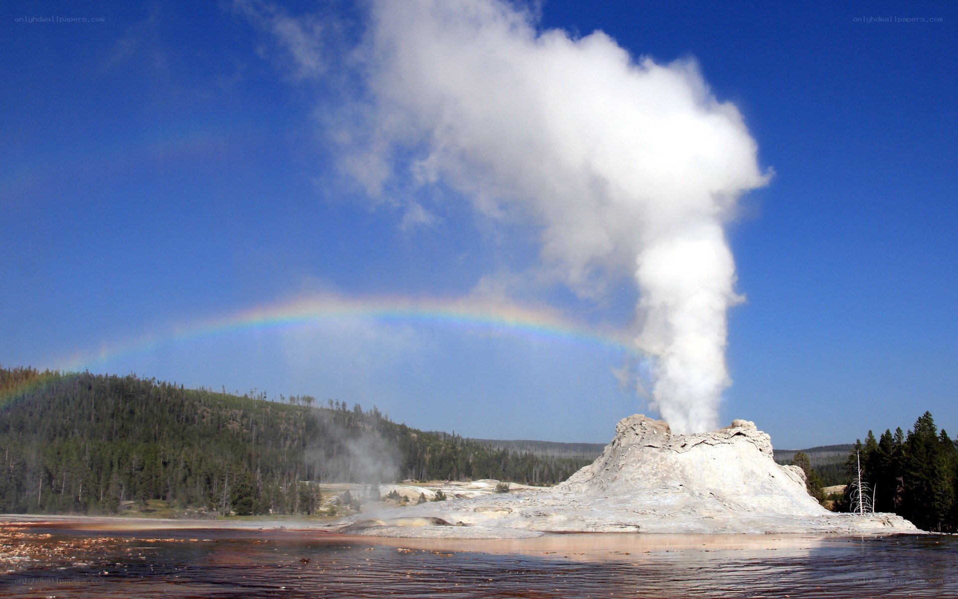 Geyser erupting with rainbow