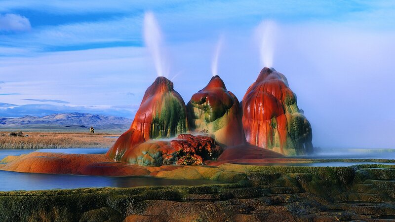 Geysers erupting in a colorful landscape