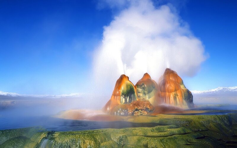 Geysers erupting in a scenic landscape