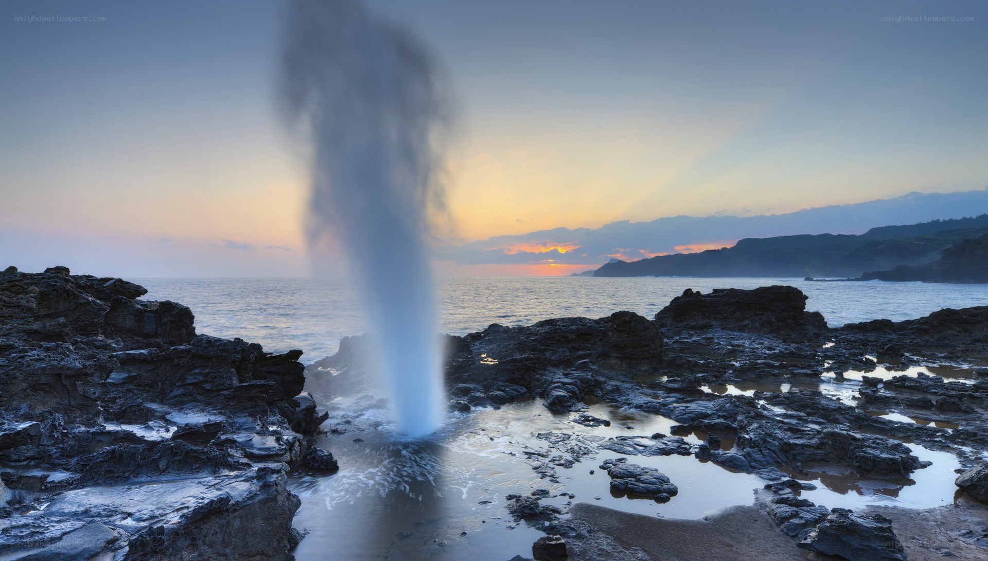 Geysir erupting at sunset