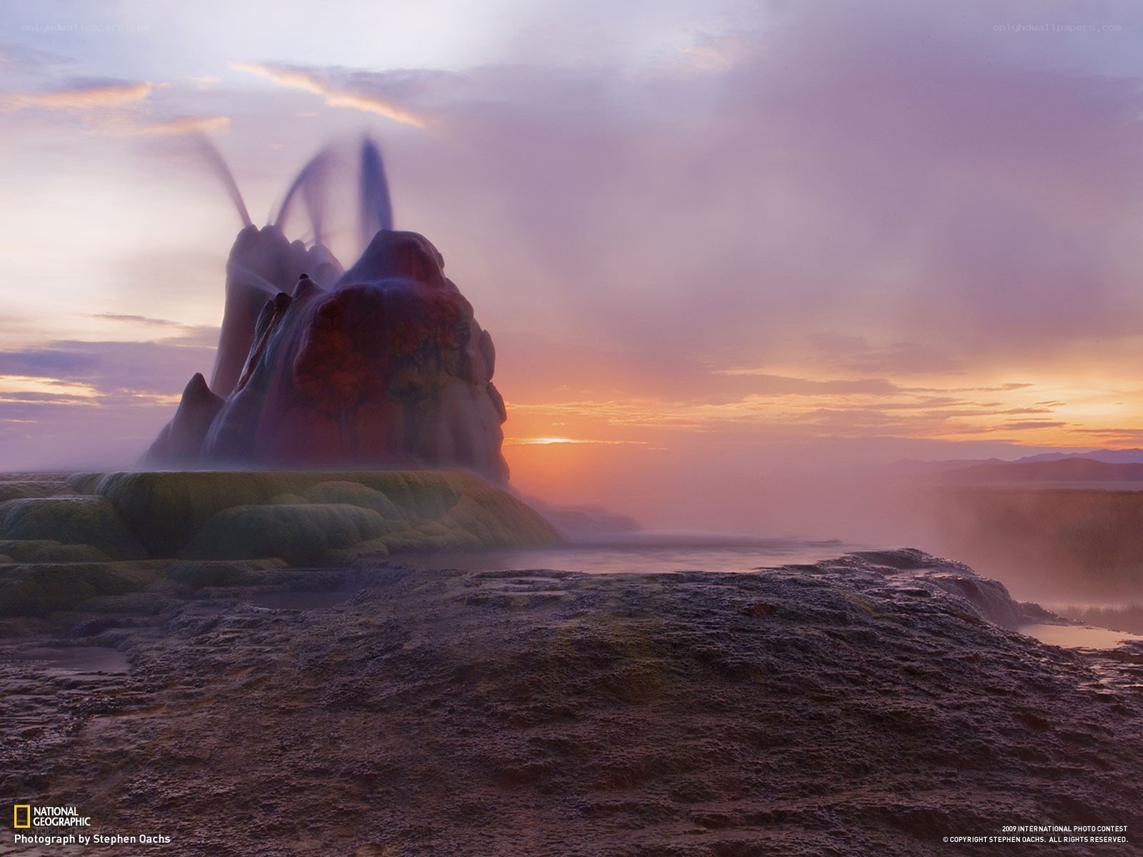 Geysir erupting at sunset