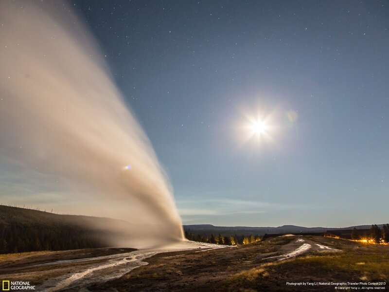 Geysir erupting under starry sky