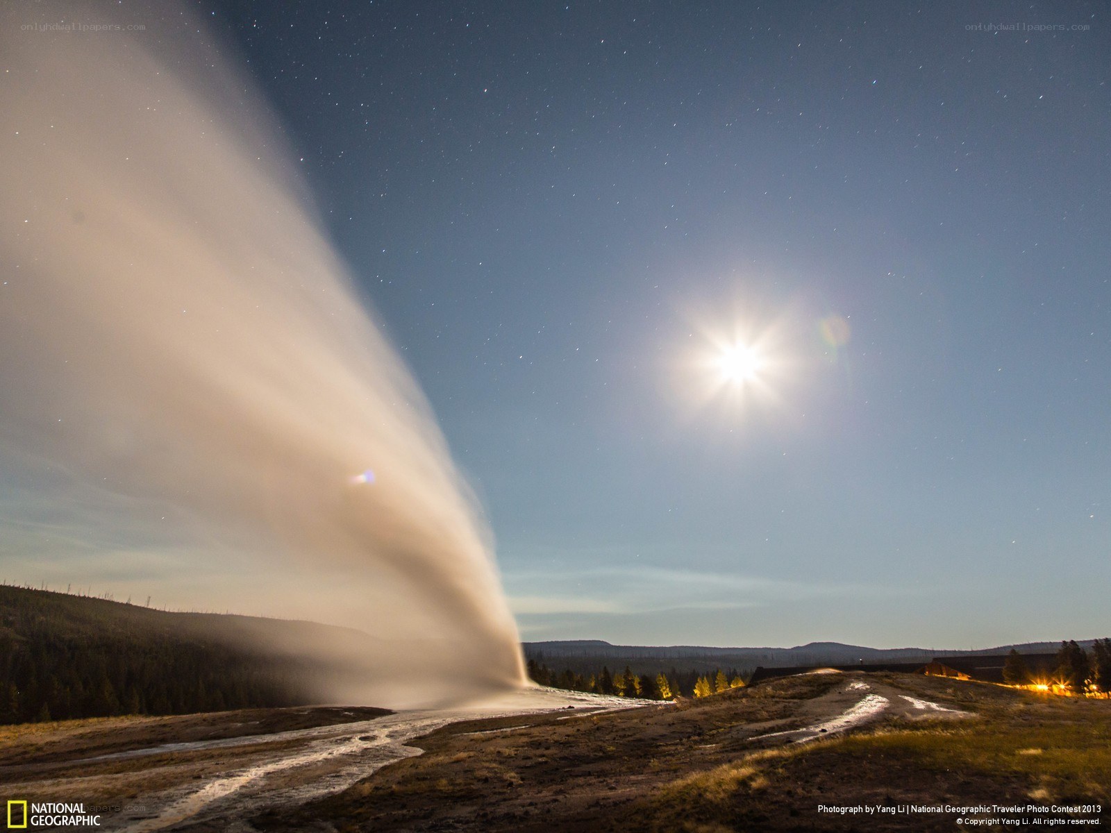 Geysir erupting under starry sky
