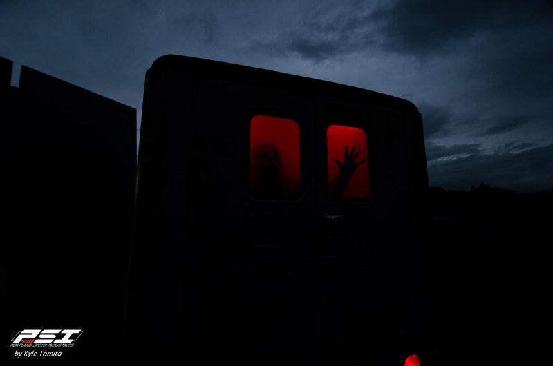 Ghostly figure in red-lit vehicle