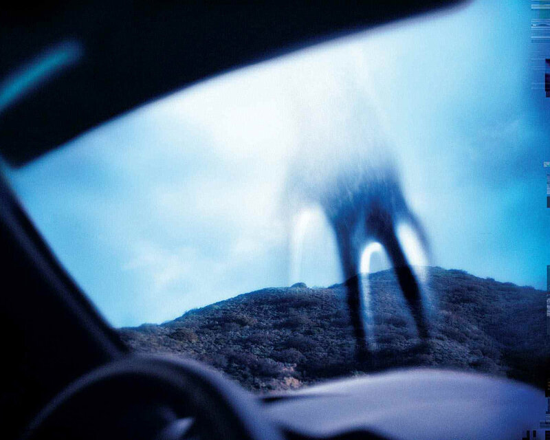 Ghostly figure seen through car window
