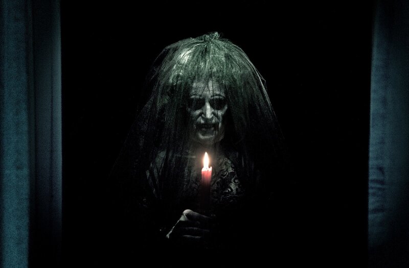 ghostly figure with candle