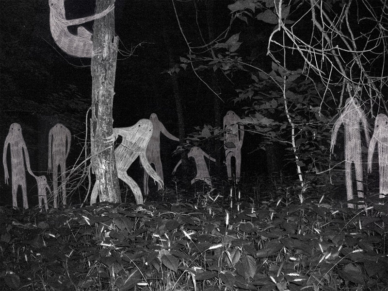 Ghostly figures in a dark forest
