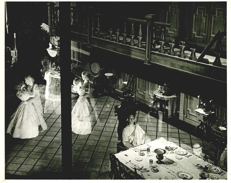 ghostly figures in a dining hall