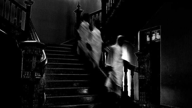Ghostly figures on a staircase