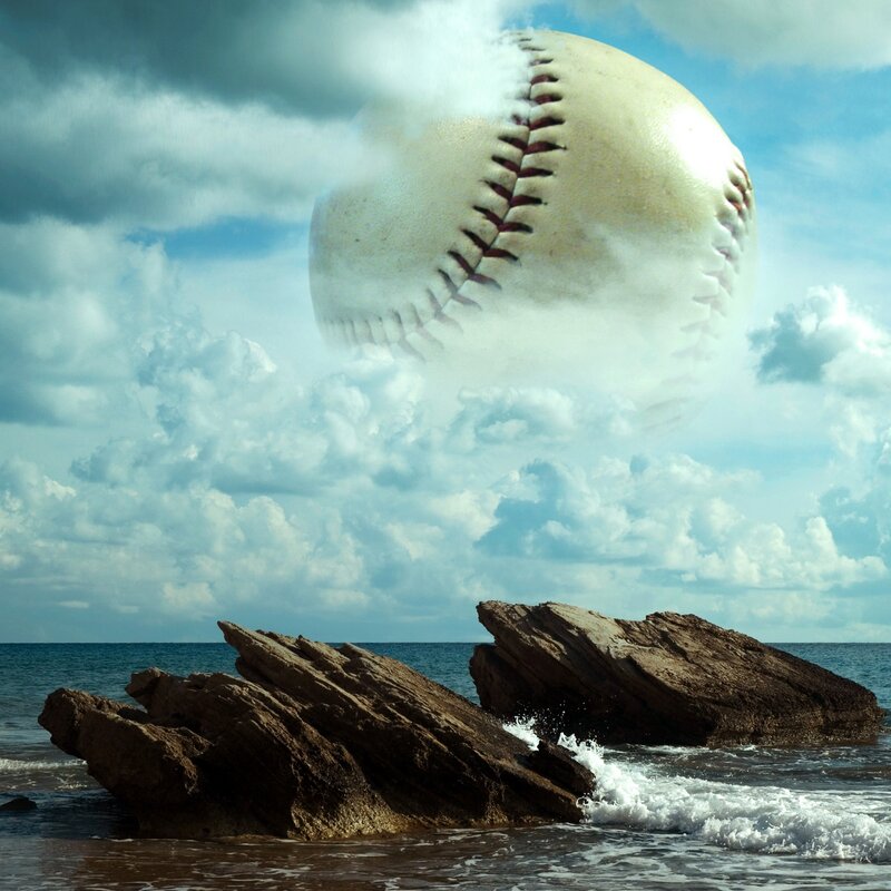 giant baseball over ocean