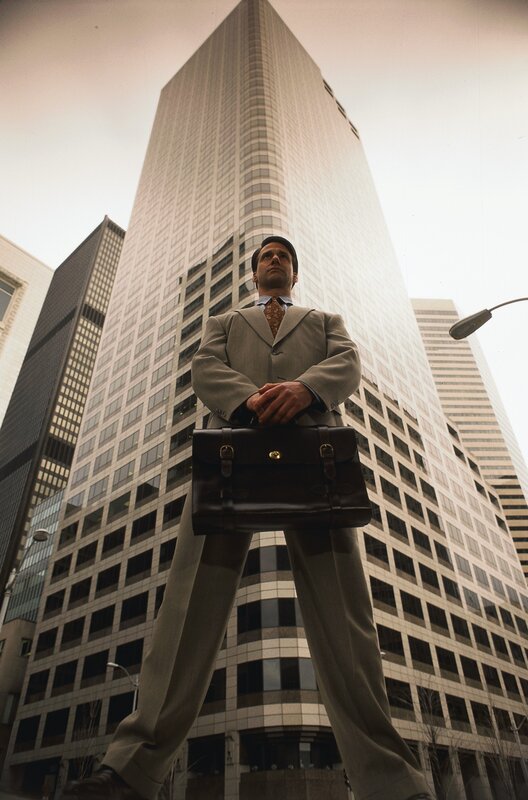 giant businessman in city