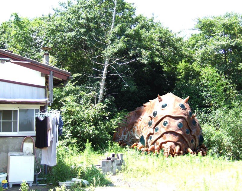 giant caterpillar sculpture in yard