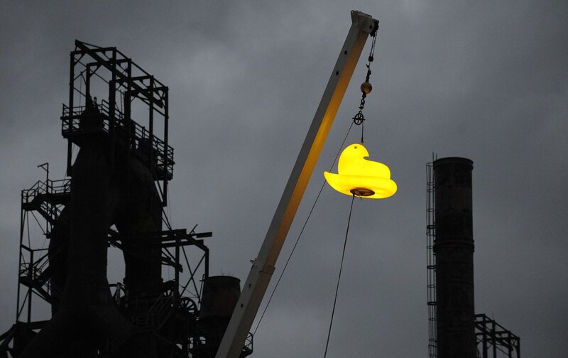 Giant glowing duck at industrial site